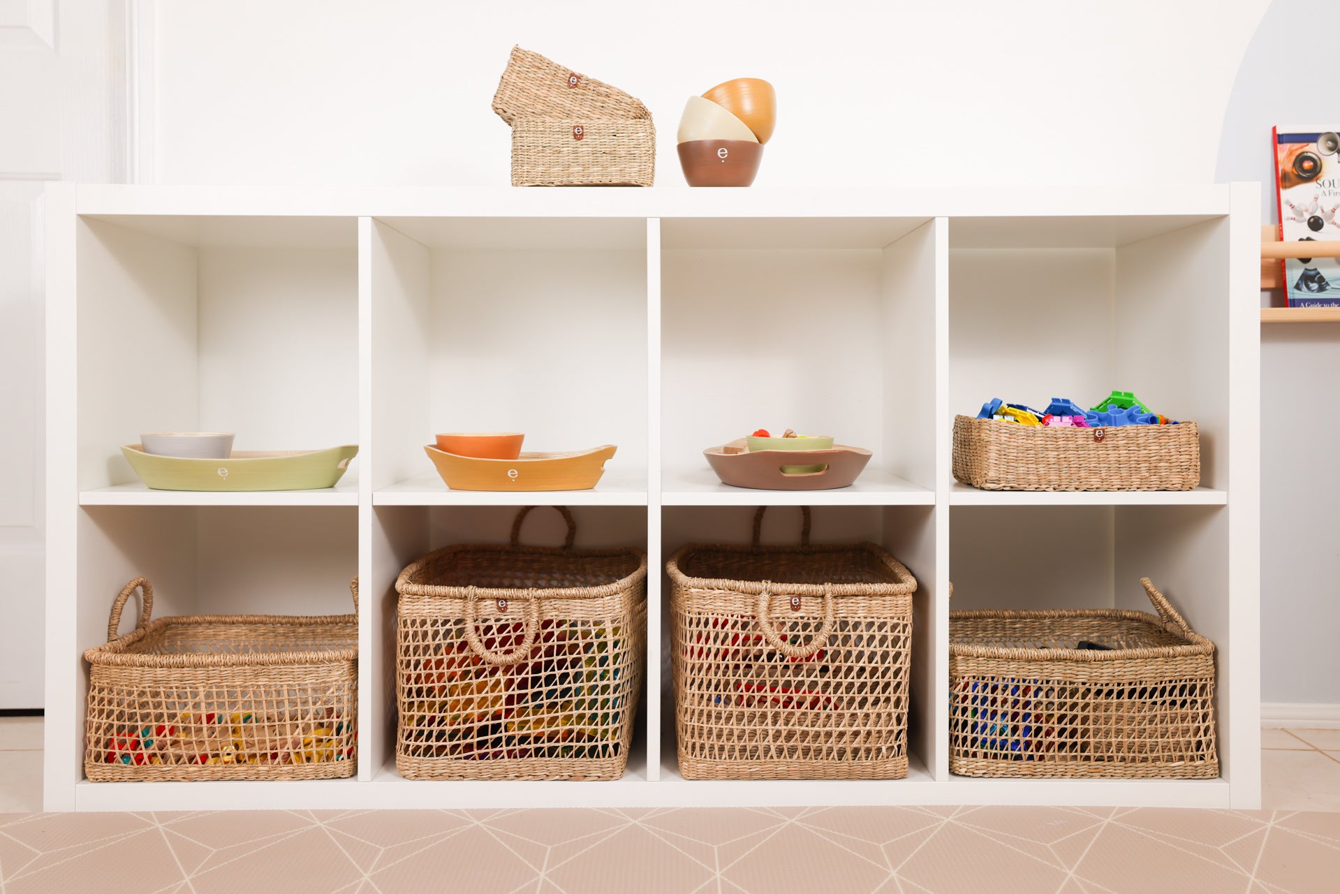 Display of  natural Monetssori baskets and trays inside an IKEA Kallax shelf