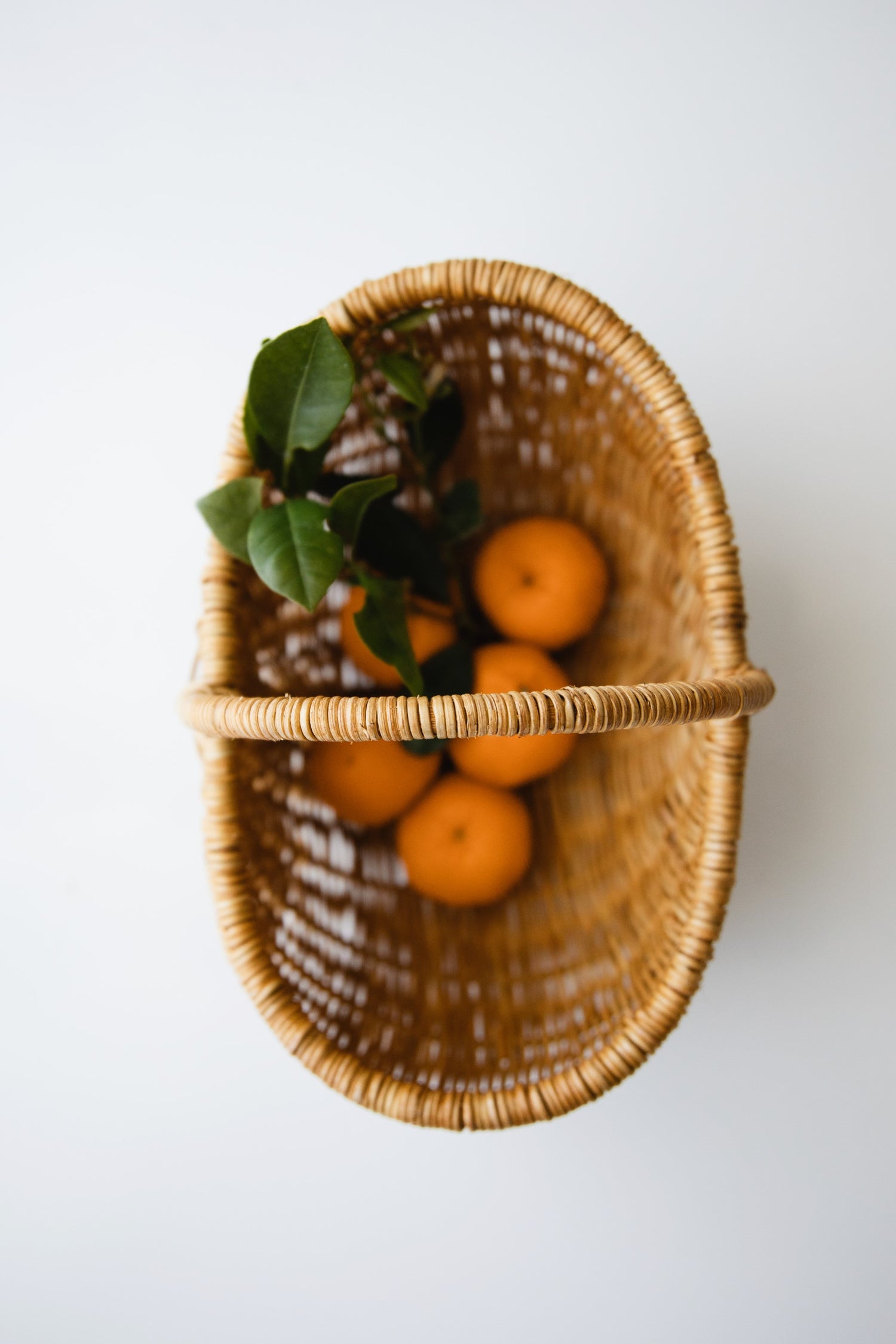 Top down image of child sized garden basket with fruits inside