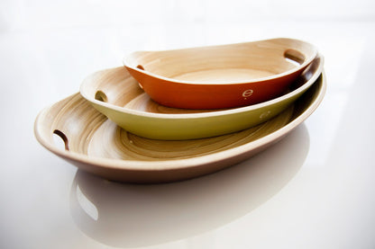 Stacked set of 3 natural spun bamboo oval Montessori trays showing natural grain texture