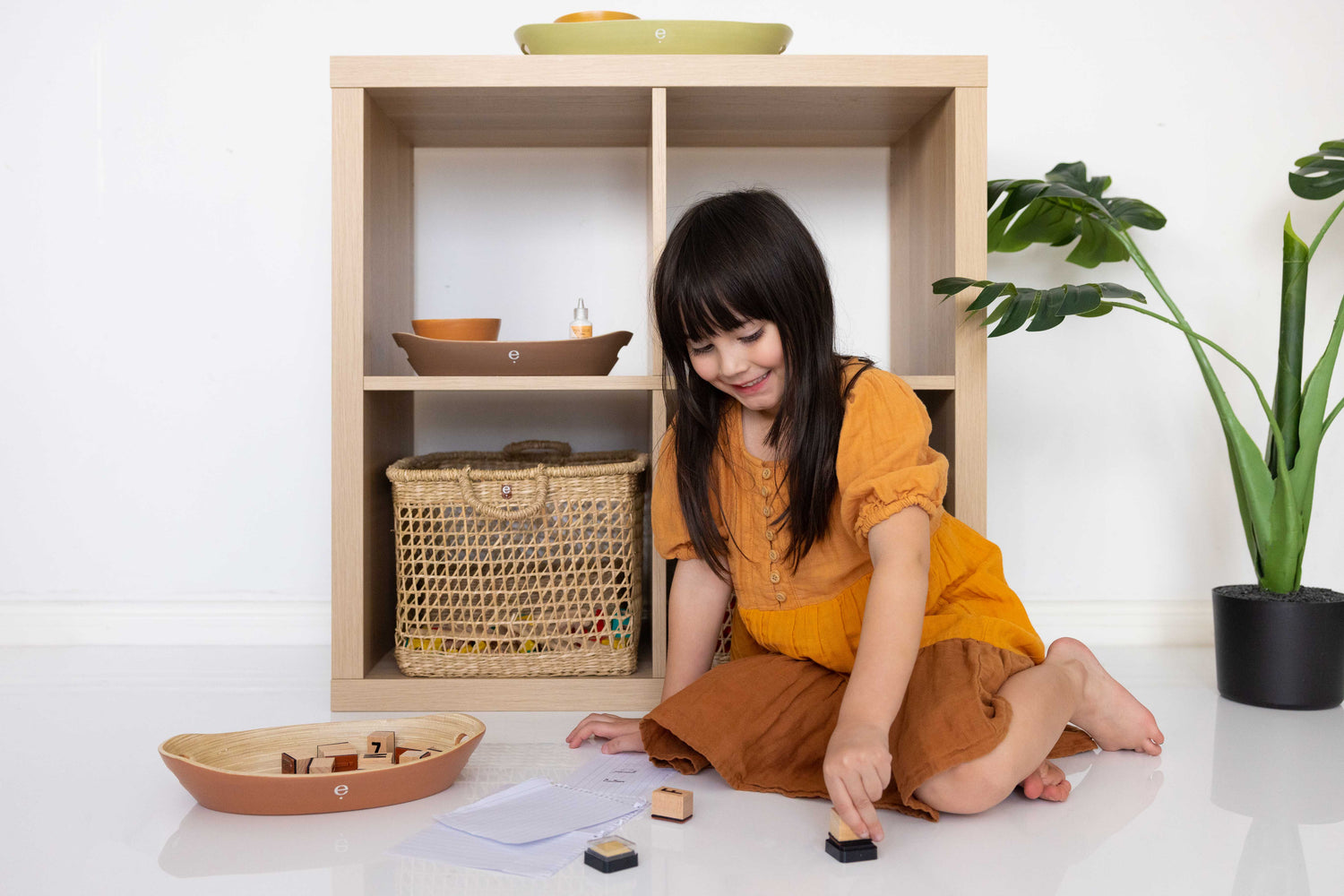 child engaged in stamping activity in a calm Montessori environment