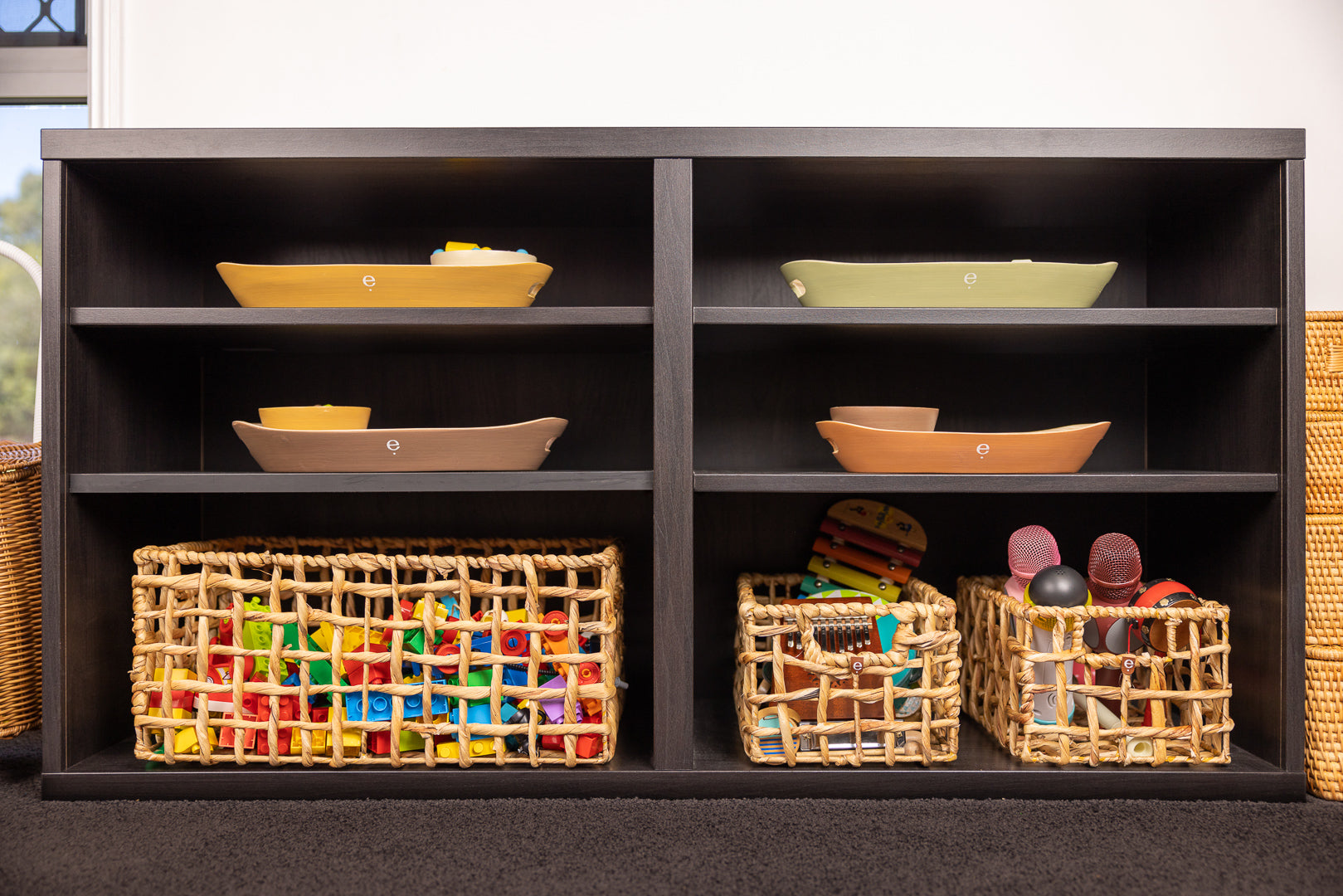 Montessori Yunus basket set and spun bamboo trays and bowls displayed on an IKEA Besta shelf