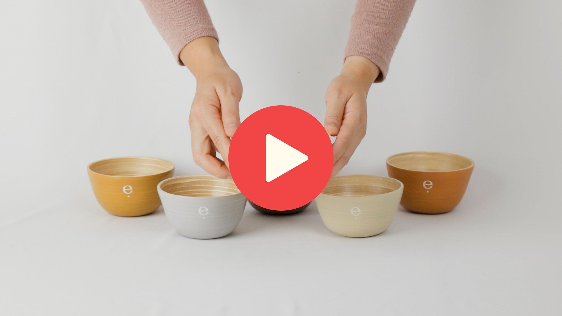 Video of hands holding up a spun bamboo bowl, displaying it and placing it down to show tip resistance