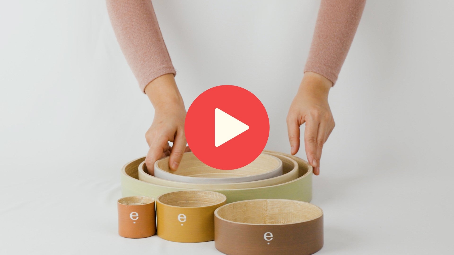 Video of hands stacking the 6 set spun bamboo circular tray set