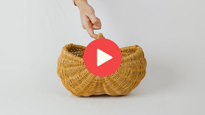 Video of hands lifting, tilting and placing down child-sized garden basket